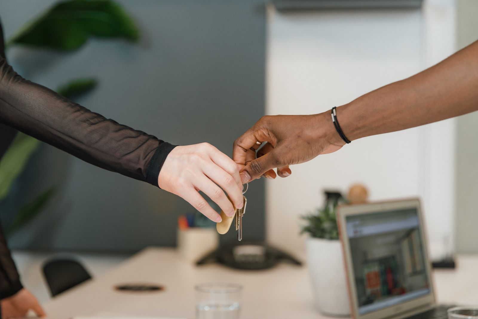 Keys being handed over across a desk