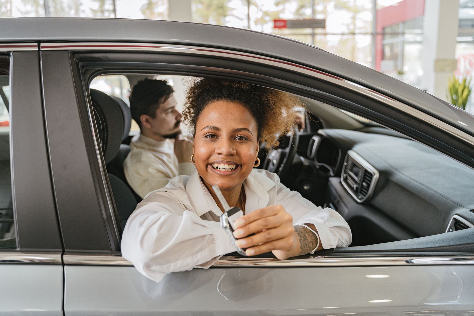 Customers holding car keys at a counter